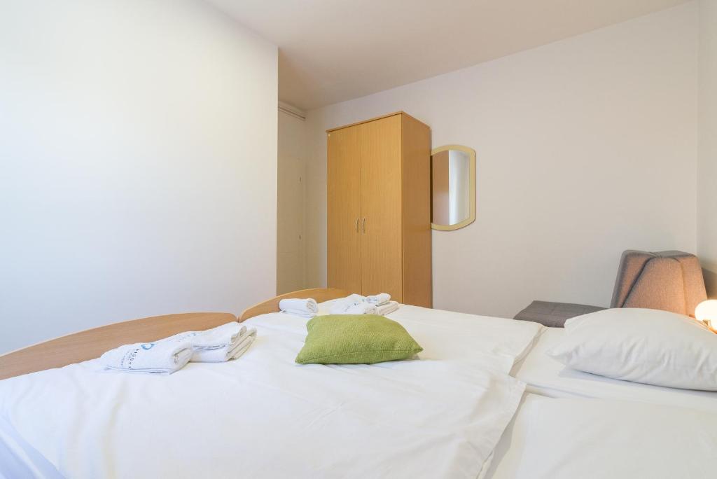 Posteľ alebo postele v izbe v ubytovaní Apartments Coronata