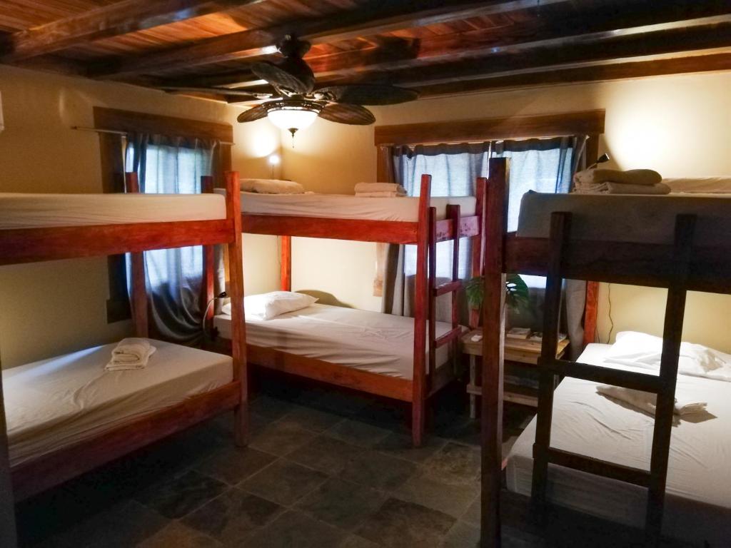 a room with four bunk beds in a house at Bodhi Santa Catalina in Santa Catalina