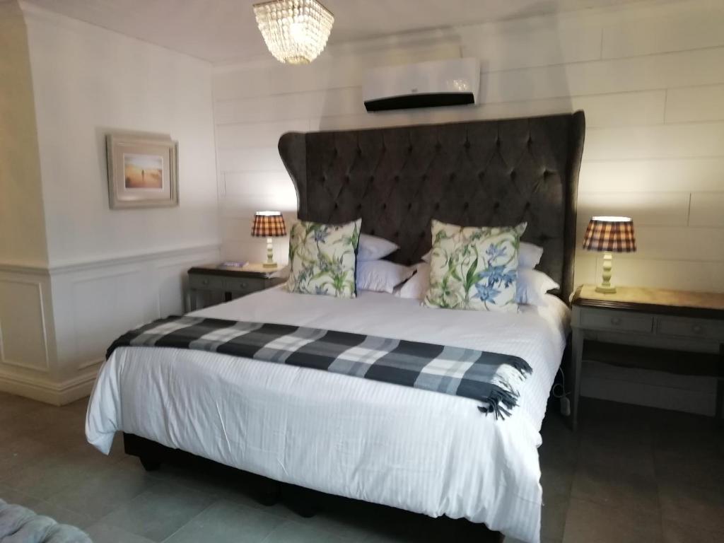 a bedroom with a bed with a black and white comforter at Linda se Dop in Nieuwoudtville