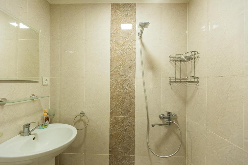 a bathroom with a shower and a toilet and a sink at Mereti in Borjomi