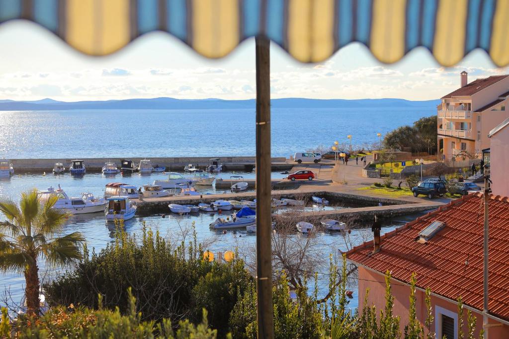 a view of a marina with boats in the water at Apartment Tea with Sea View in Petrcane