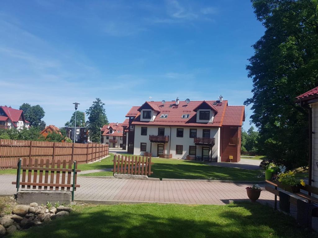 a large house with a fence in a yard at Boczna 9 Apartament in Karpacz