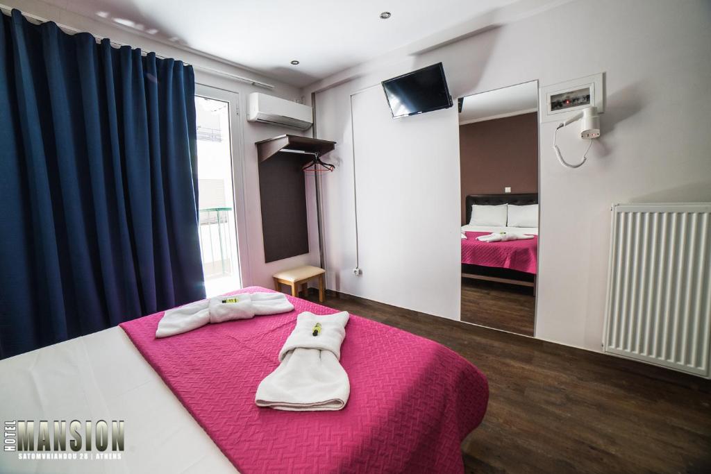Ένα ή περισσότερα κρεβάτια σε δωμάτιο στο Mansion Hotel
