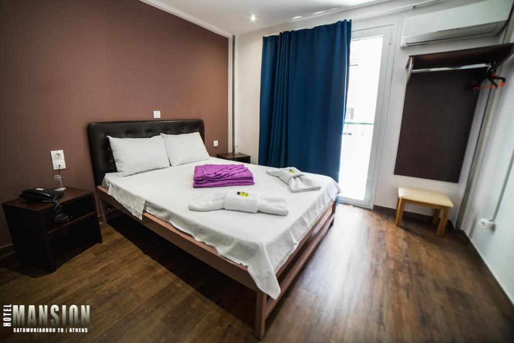 Ένα ή περισσότερα κρεβάτια σε δωμάτιο στο Mansion Hotel