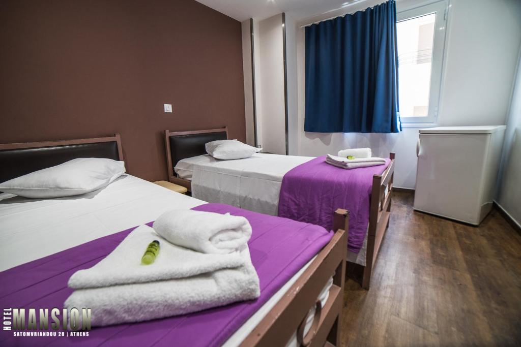 Ένα ή περισσότερα κρεβάτια σε δωμάτιο στο Mansion Hotel