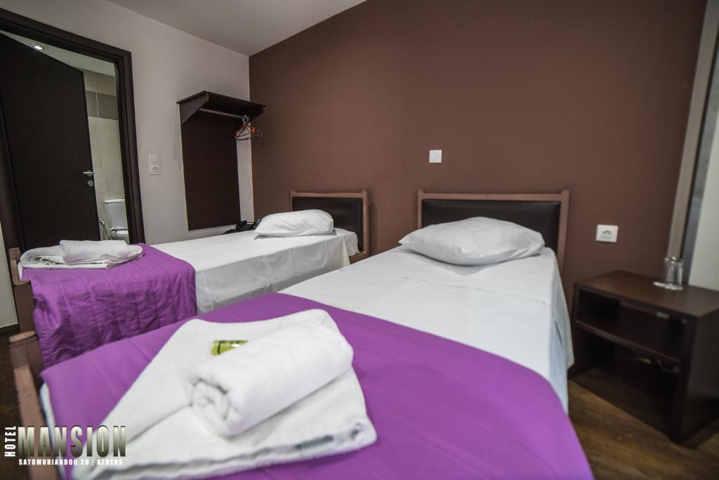 Ένα ή περισσότερα κρεβάτια σε δωμάτιο στο Mansion Hotel