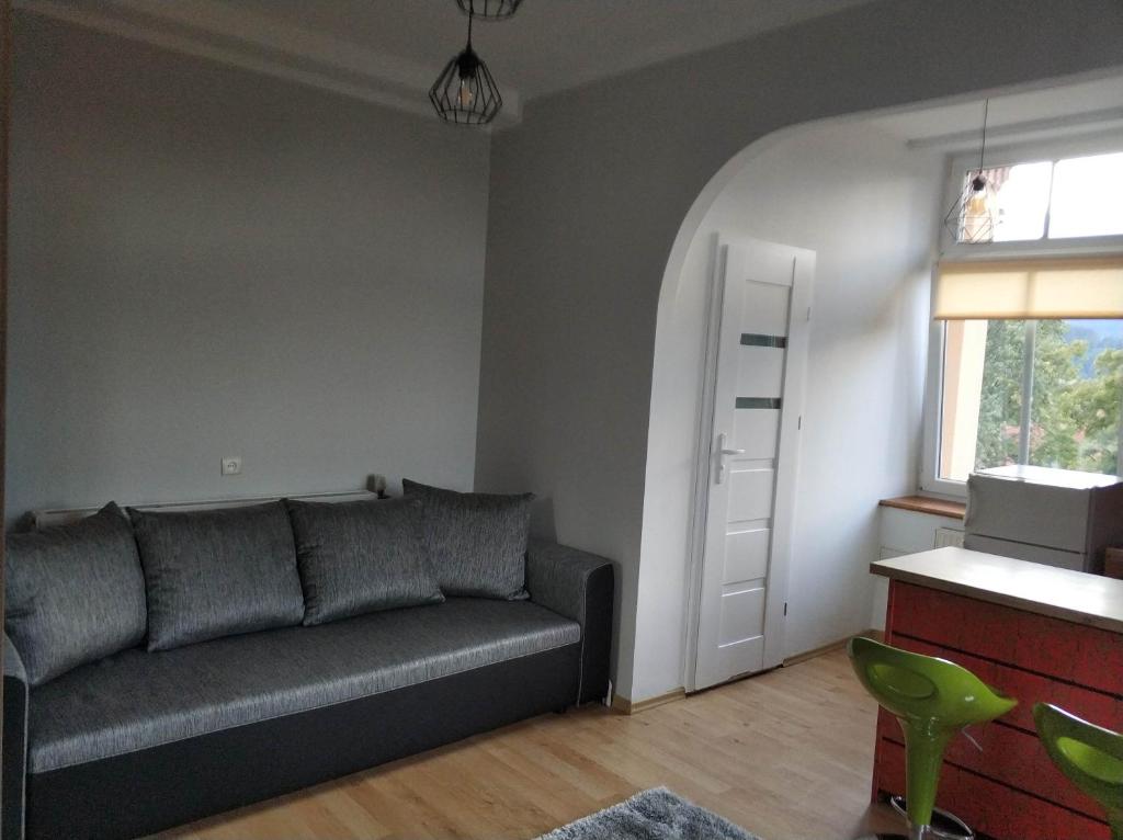 a living room with a couch and a window at Przy Leśnej in Szklarska Poręba
