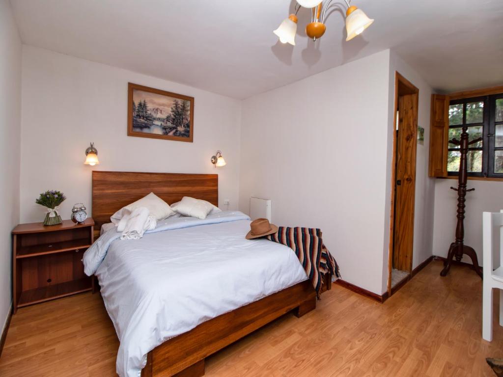 Postel nebo postele na pokoji v ubytování Hosteria Papagayo Cotopaxi