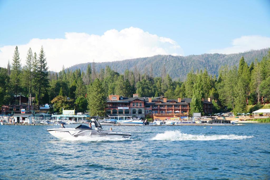 a boat in the water in front of a resort at The Pines Resort & Conference Center in Bass Lake