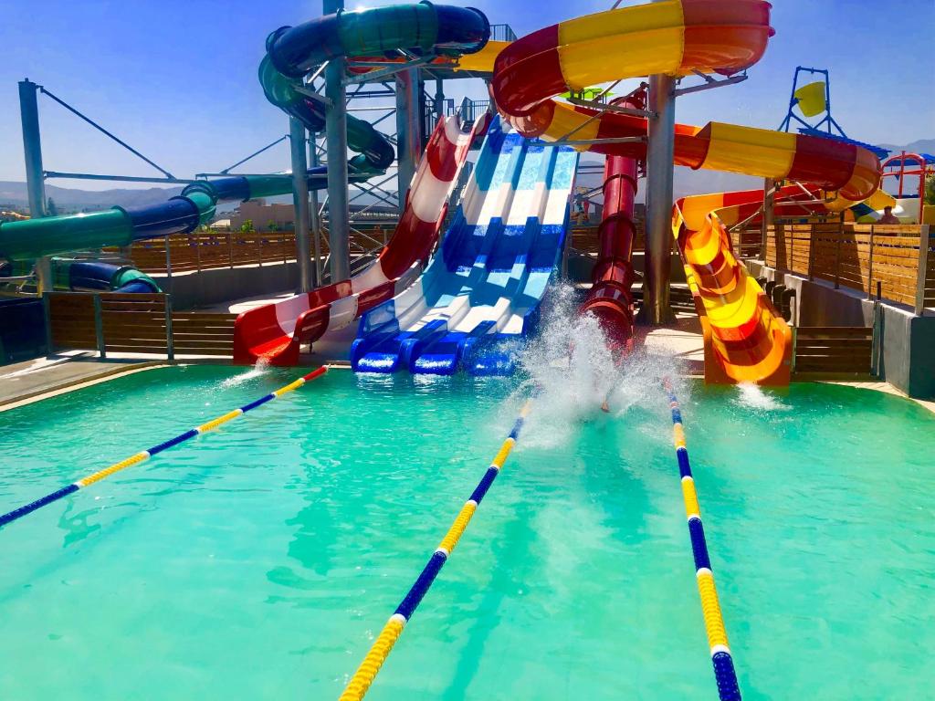 a pool on a cruise ship with a water slide at Selini Suites & Waterpark in Kolymvari