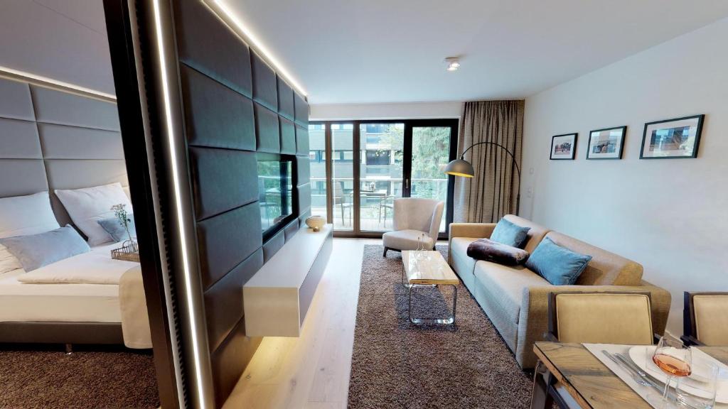 a living room with a couch and a table at White Pearl Apartment 1.04 in Timmendorfer Strand