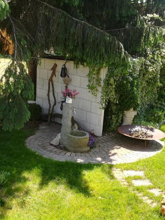 a garden with a fountain in the middle of a yard at Angel's Nest Apartment in Komenda