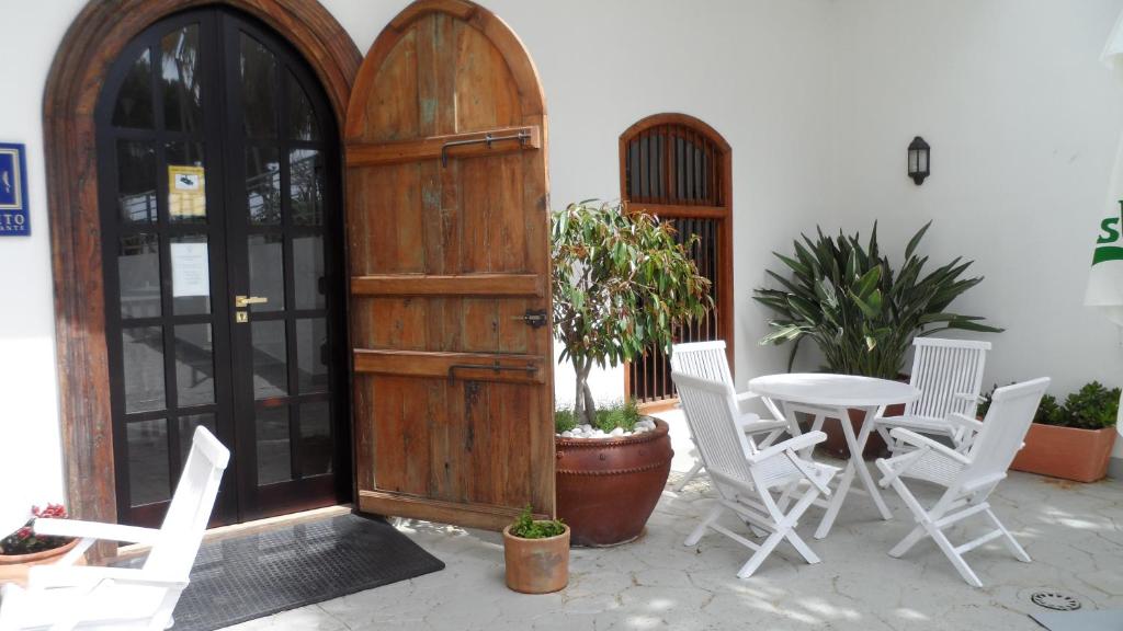 a patio with a table and chairs and a wooden door at Santuario San José in San José
