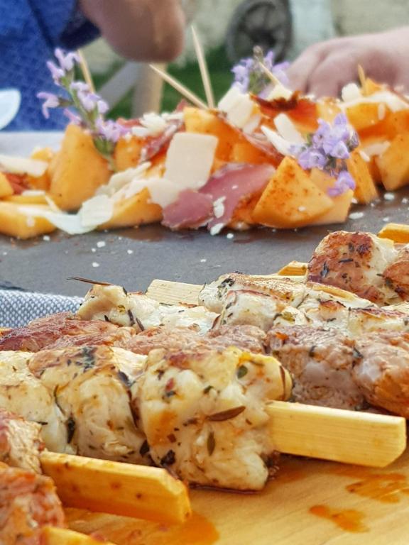 a plate of food with chicken and cheese on a table at Les Hauts De Chalonne in Le Gond-Pontouvre