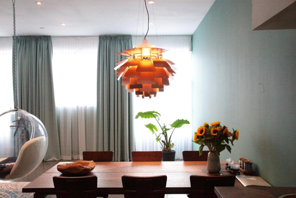 a dining room with a table and a chandelier at Private Studio - FREE PARKING in Amsterdam