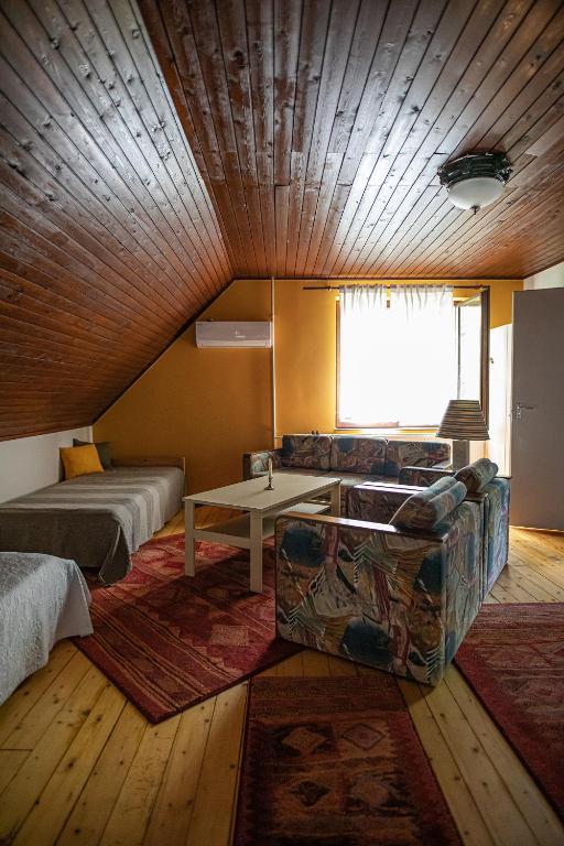 A bed or beds in a room at Tusculanum Panzió