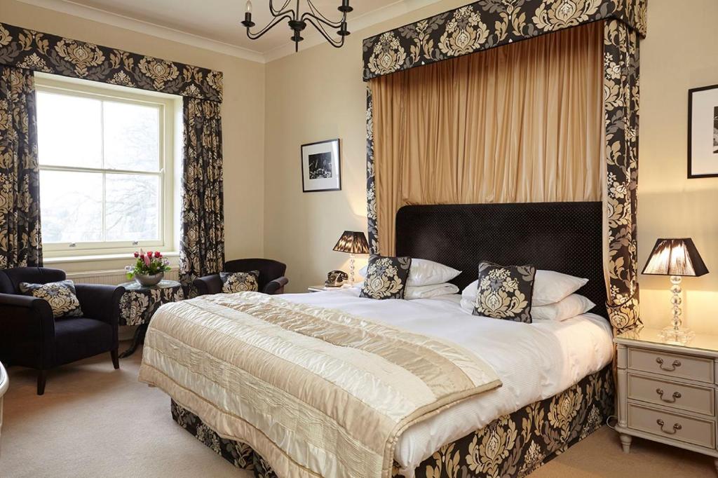 a bedroom with a large bed and a window at The Royal Hotel in Ventnor
