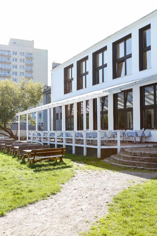 ソポトにあるSopocki Zdrójの正面にベンチとテーブルがある建物
