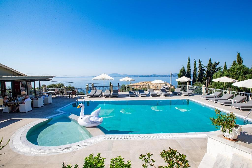 a swimming pool with a swan in a resort at Locanda Barbati Luxury ApartHotel in Barbati