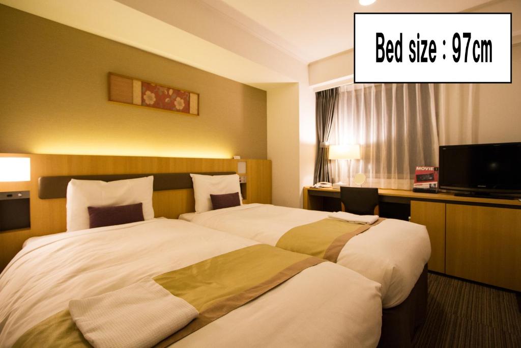 Postel nebo postele na pokoji v ubytování Hotel Sunroute Asakusa