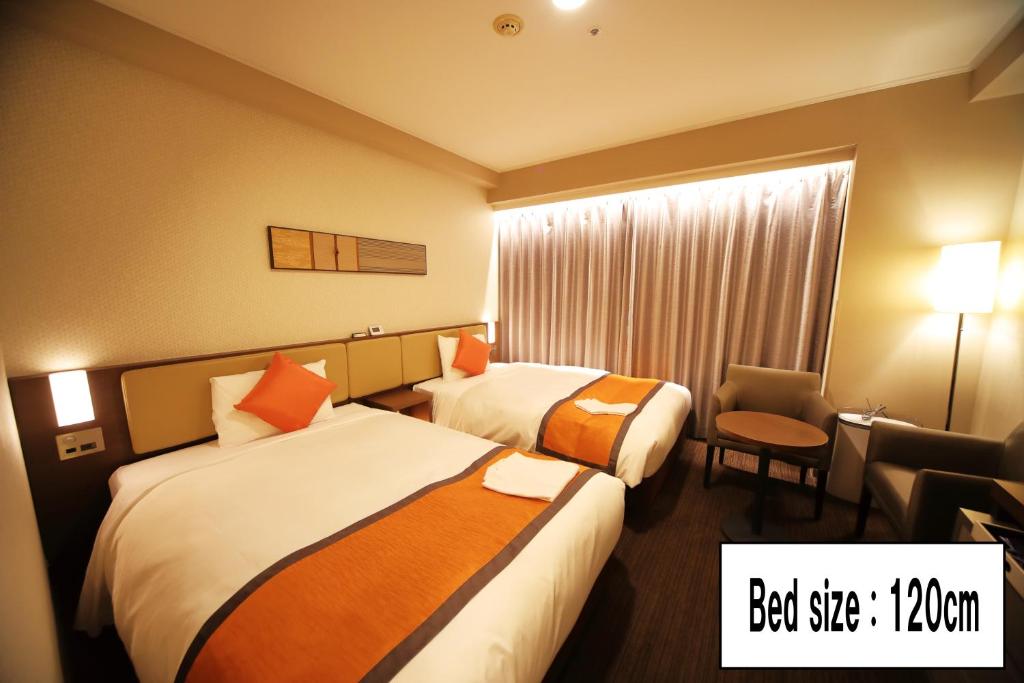 Postel nebo postele na pokoji v ubytování Hotel Sunroute Asakusa