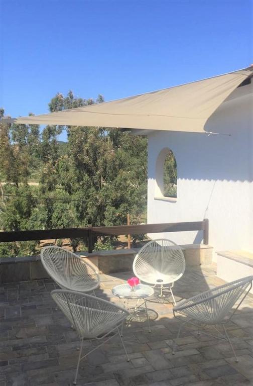 two chairs and a table on a patio at Villa Spartias in Skiathos