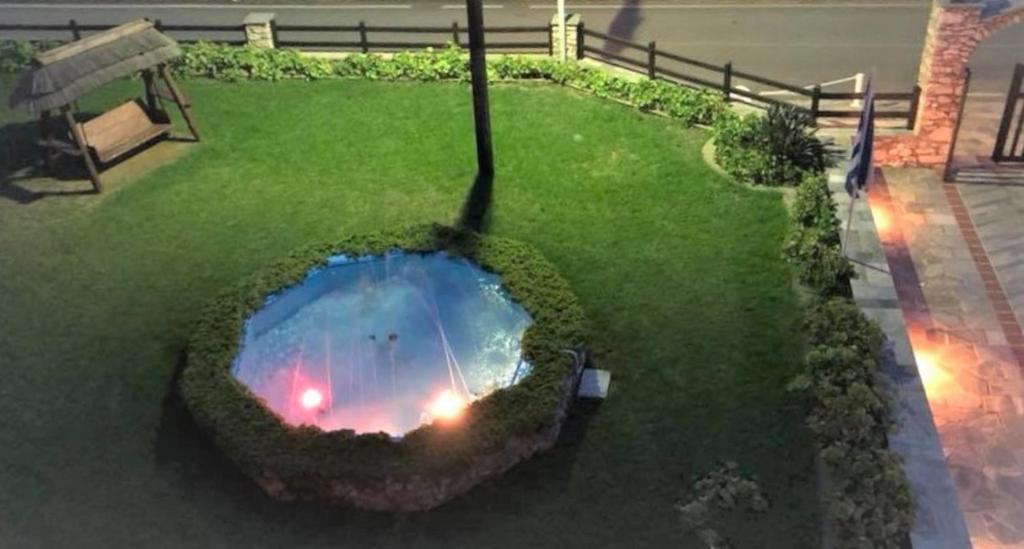 a garden with a fire pit in the grass at Villa Spartias in Skiathos