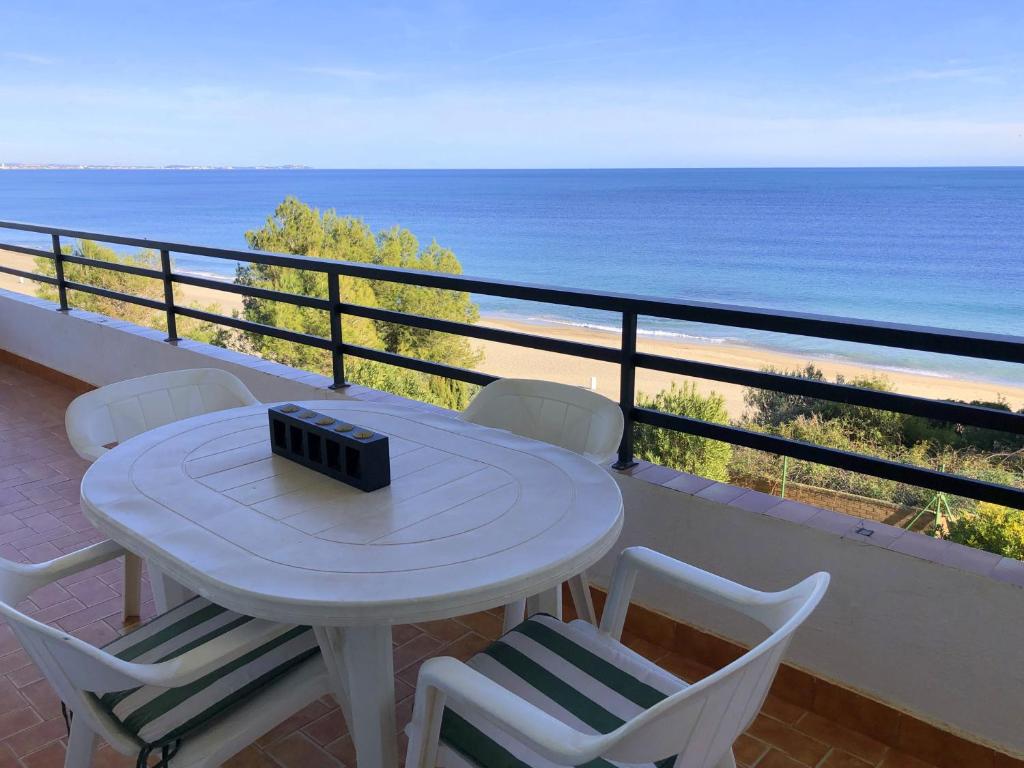 een tafel en stoelen op een balkon met uitzicht op de oceaan bij Rentalmar Horizon in Miami Platja