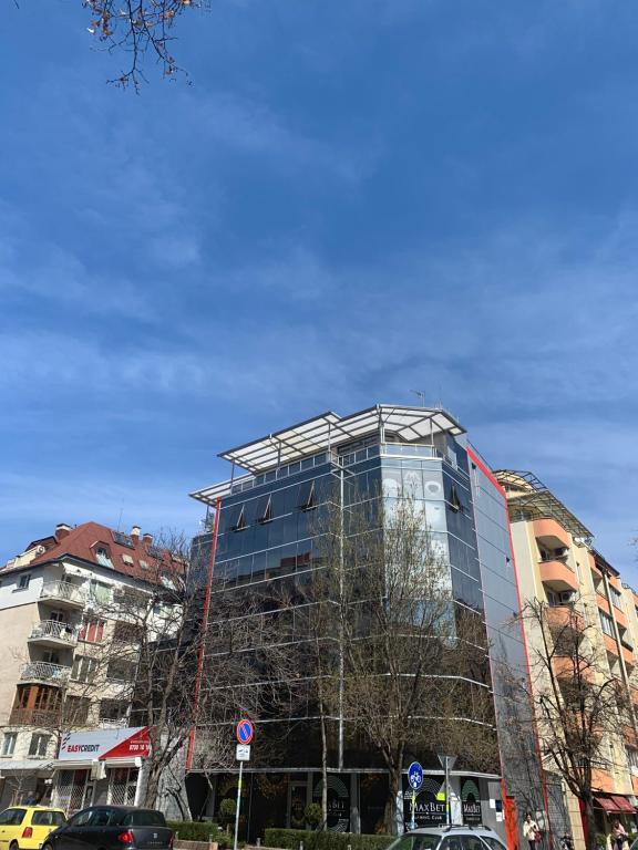 a glass building being constructed in a city at Self-Check Studio Lilia 4 next to 24 hours open food and drink shop and free parking area in Sofia