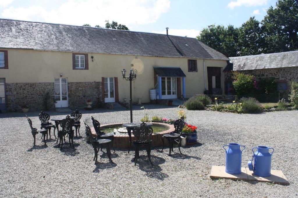 a patio with tables and chairs in front of a building at Lavender Cottage in Gorges