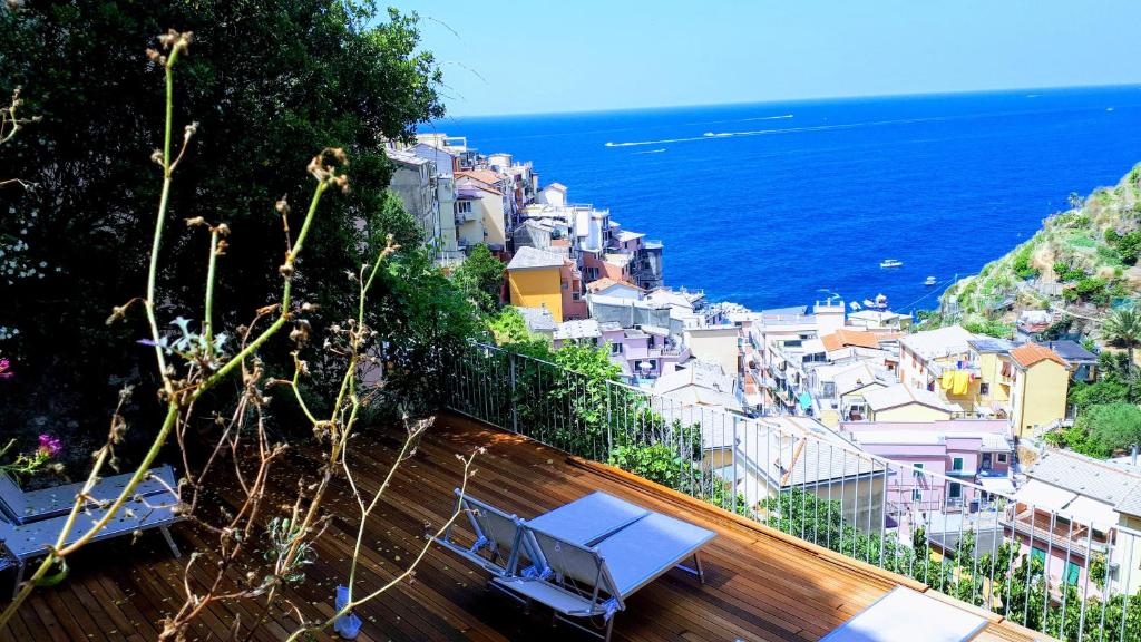 a view of a city and the ocean from a balcony at Olimpo Affittacamere in Manarola