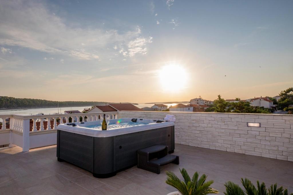 a hot tub on the roof of a house at Villa Harmony Rab in Barbat na Rabu