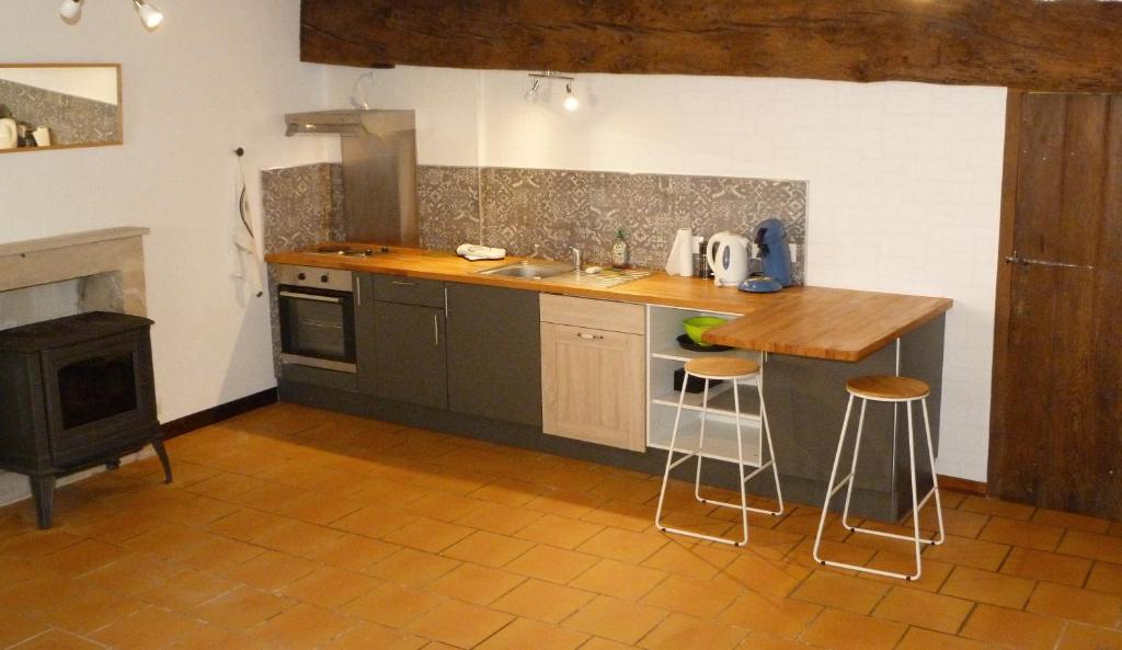 a kitchen with a counter and a sink and a stove at l'atelier du relieur in Montmorillon