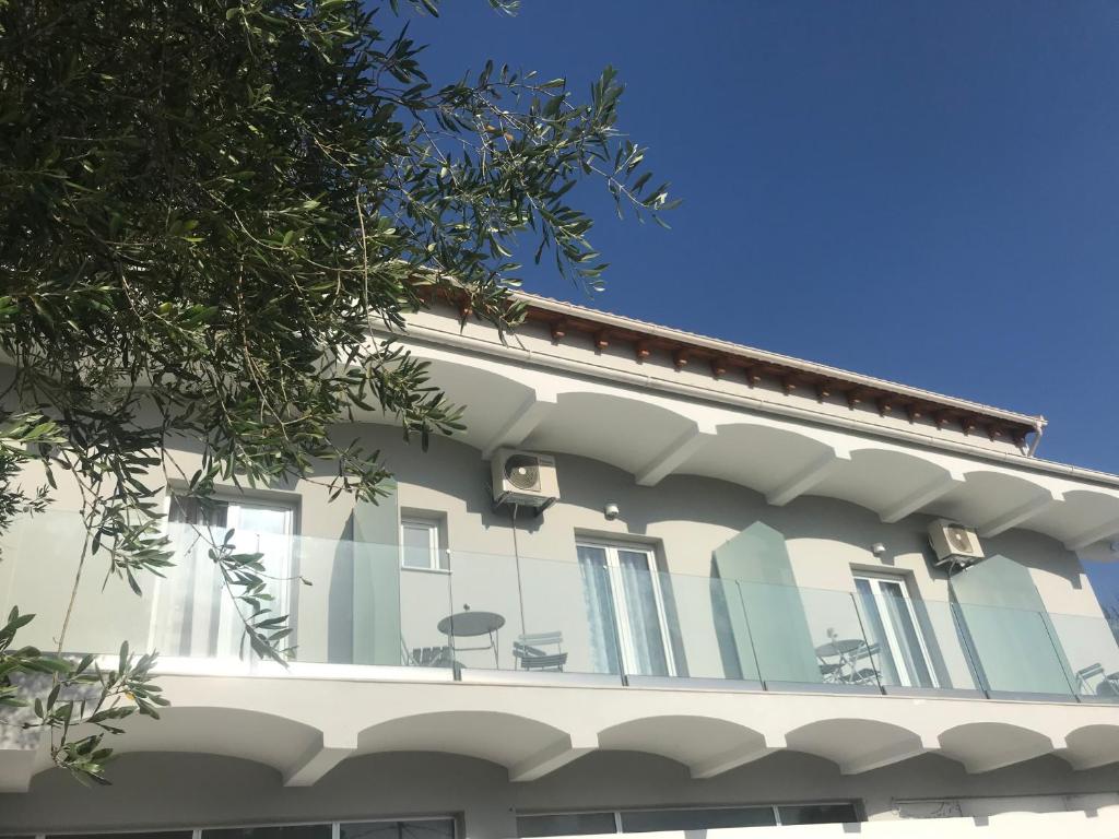 a white building with windows on top of it at Terpsichore Boutique Appartments in Dassia