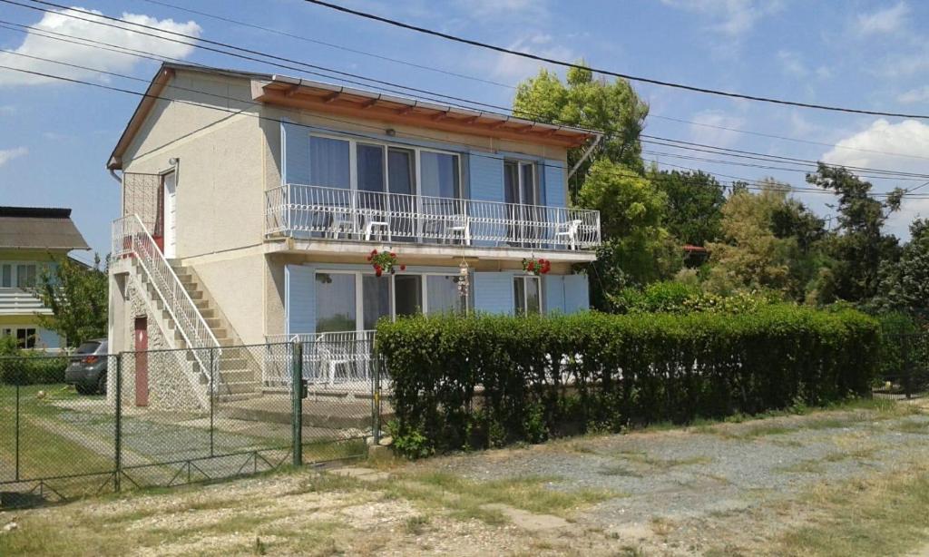 a house with a fence in front of it at Cozy studio #1, with balcony in 2 Mai
