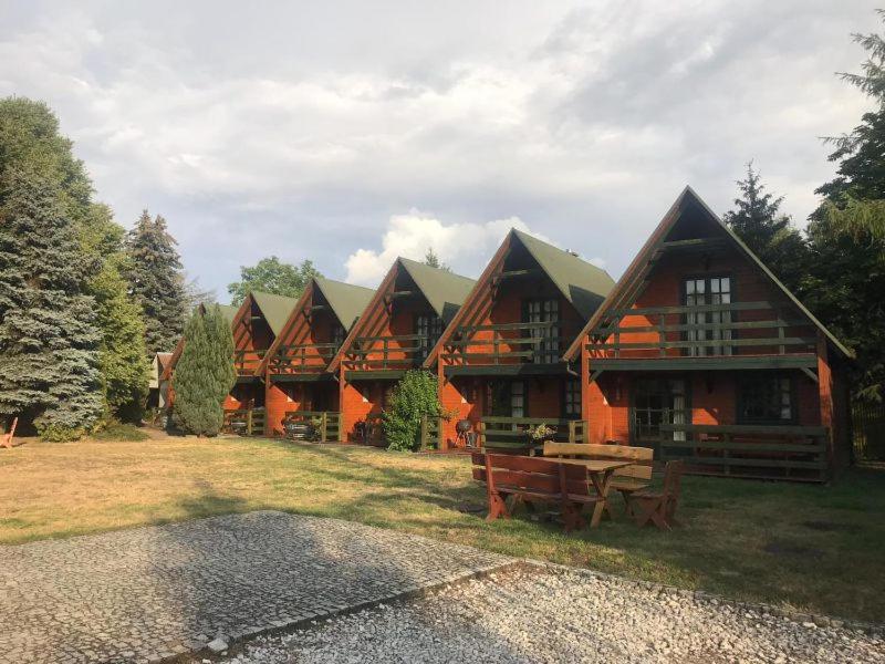 a large wooden house with a picnic table in front of it at Ośrodek Wypoczynkowy OAZA in Wągrowiec