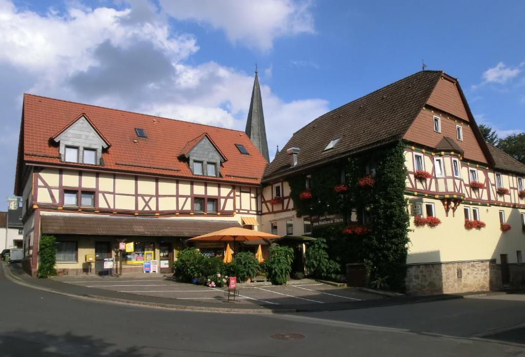 a group of buildings in a town with a church at Fritz'es Goldener Stern in Schauenburg