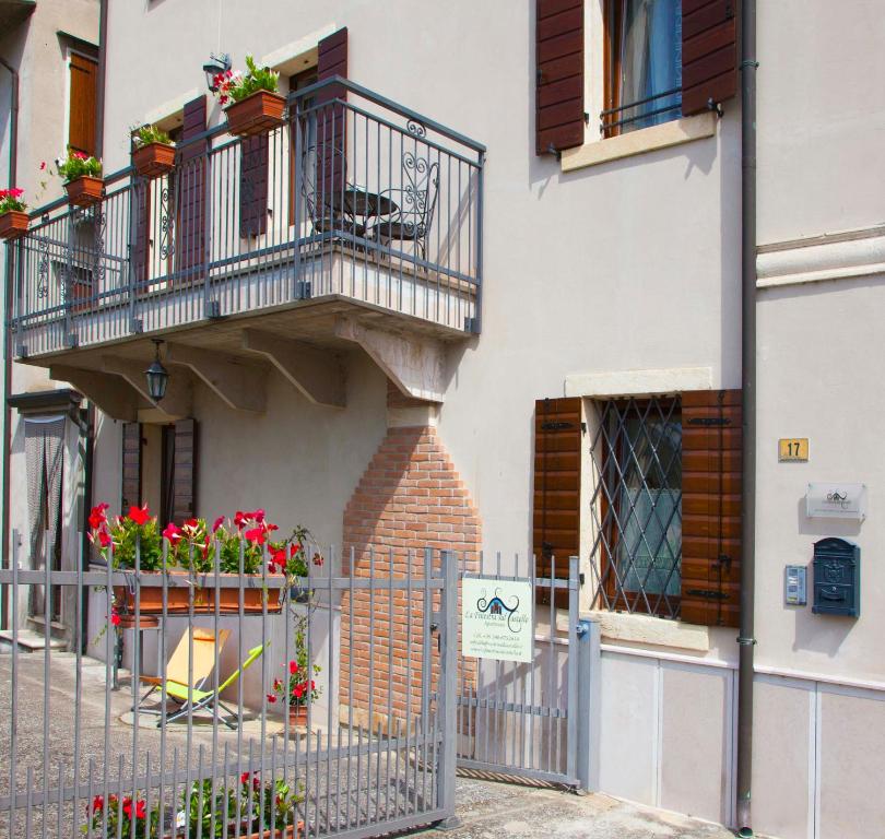 um edifício com uma varanda com flores em La Finestra Sul Castello em Soave