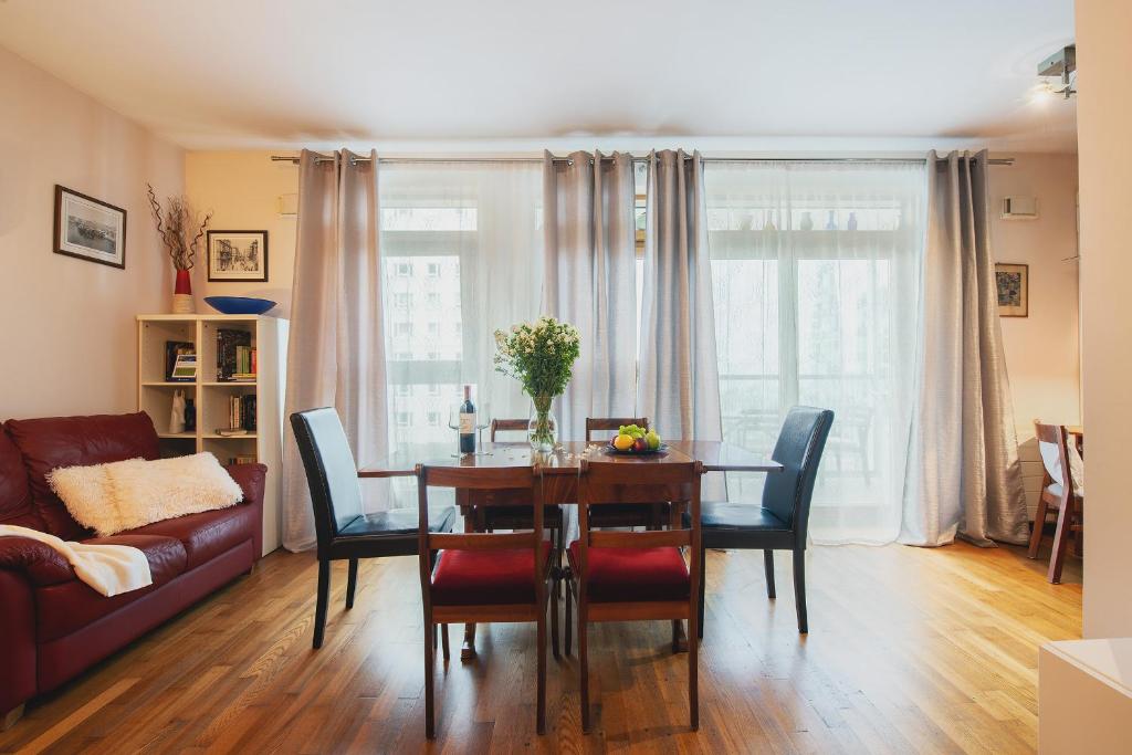 un soggiorno con tavolo e divano di P&O Serviced apartments CH ARKADIA 2 a Varsavia