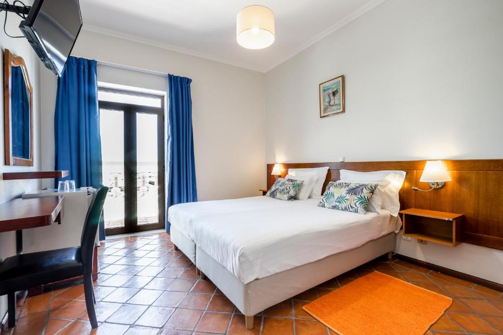 Een bed of bedden in een kamer bij Residencial Mares