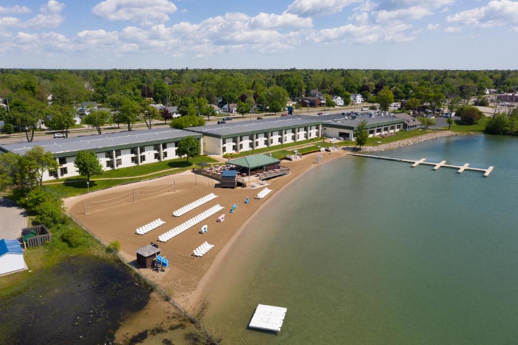 an aerial view of a resort with a beach and water at Tawas Bay Beach Resort & Conference Center in East Tawas