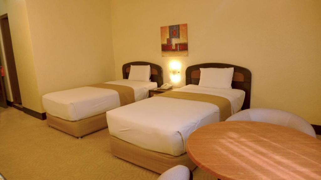 Postel nebo postele na pokoji v ubytování Rothman Hotel