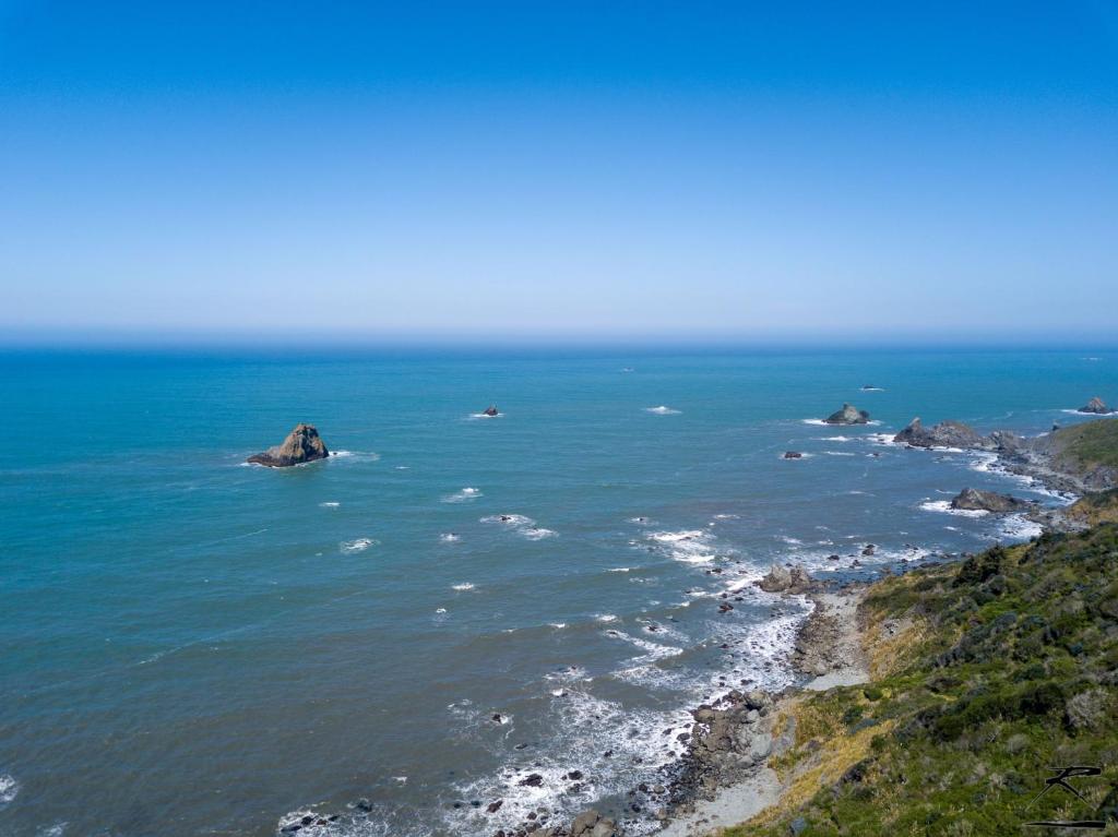 an aerial view of the ocean with rocks in the water at Trinidad Vacation Rental Sleeps 4 in Trinidad