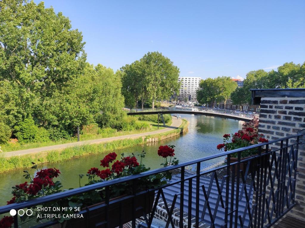 a view of a river with a bridge and flowers at HORTILLON in Amiens