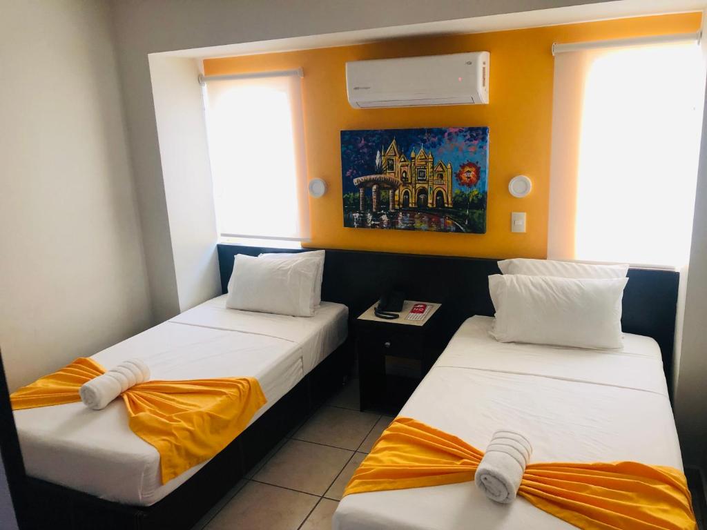 Postel nebo postele na pokoji v ubytování Hotel Belisario INN