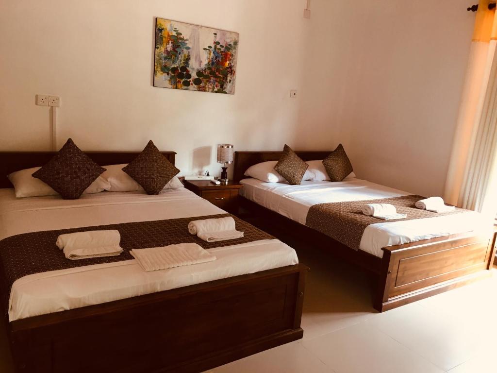 Postel nebo postele na pokoji v ubytování Sarvodaya Samma Vaasa Residence