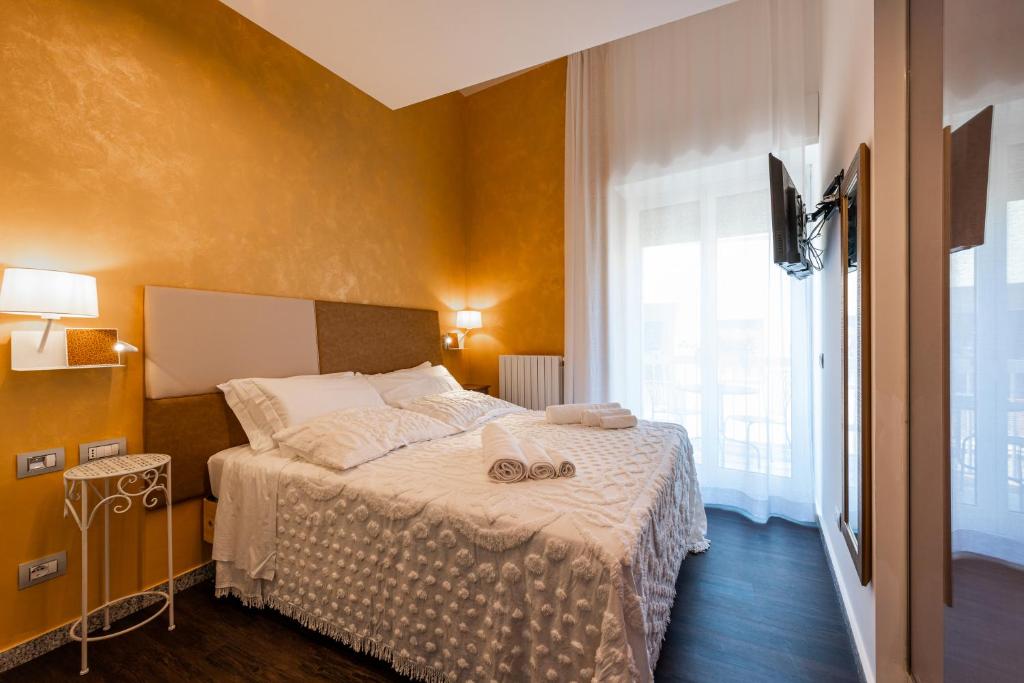 a bedroom with a bed with two shoes on it at Sinestesia in Polignano a Mare