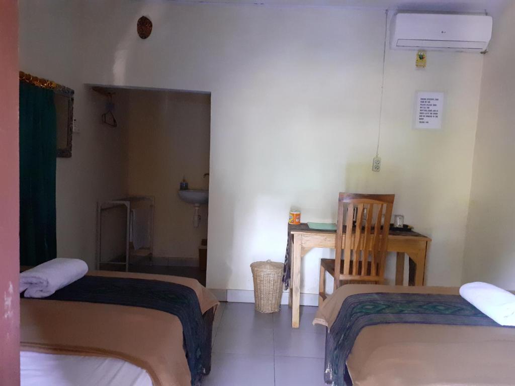 Postel nebo postele na pokoji v ubytování Griya Bun Sari