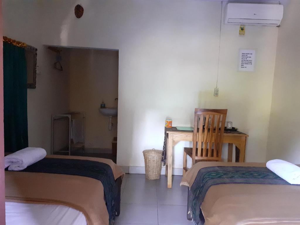 Postel nebo postele na pokoji v ubytování Griya Bun Sari