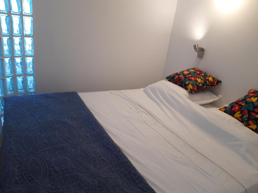 a small bedroom with a bed and a window at Antibes: A nest perched on the sea! in Antibes